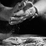 Sprinkling flour on pasta