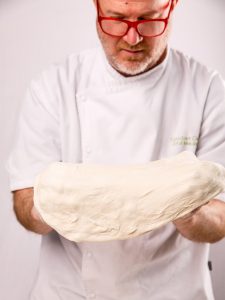 Chef Gord stretching Pizza dough