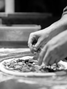 making pizza in the pizzeria kitchen